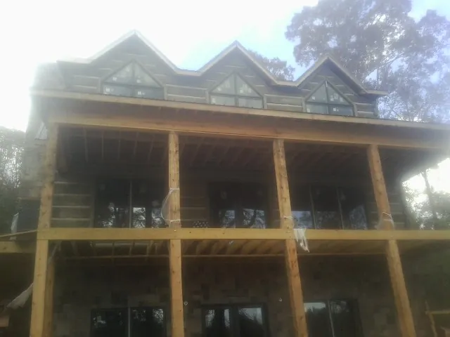 Dormers and porch framing on a large log home under construction in Zanesville